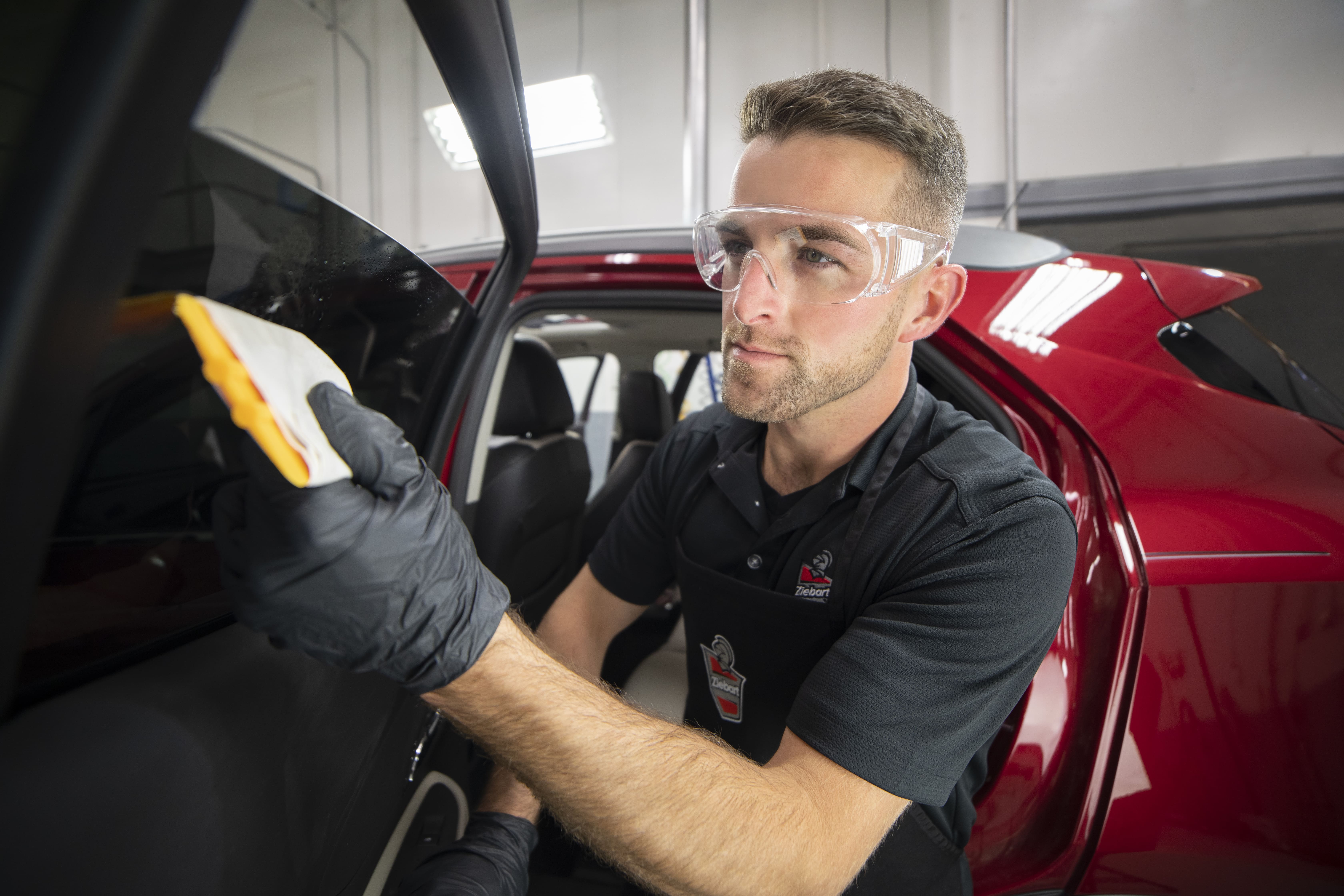 Ziebart technician finishing a vehicle exterior